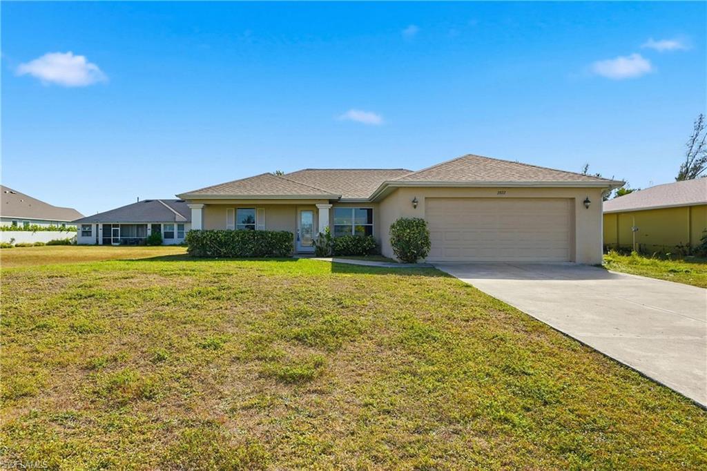 Image 1: Single story home with stucco siding, a front lawn, driveway, and a garage