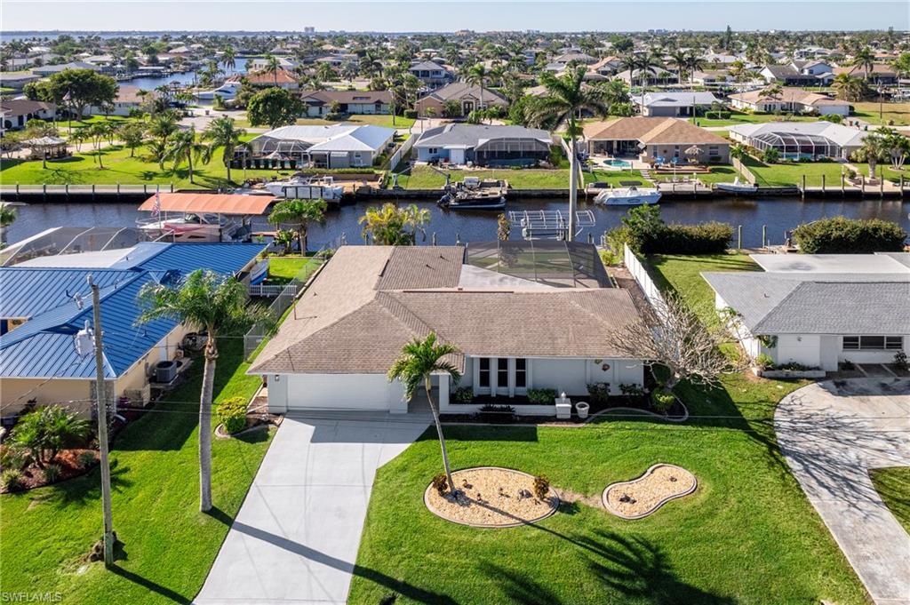Image 2: Aerial view of residential area featuring a large body of water
