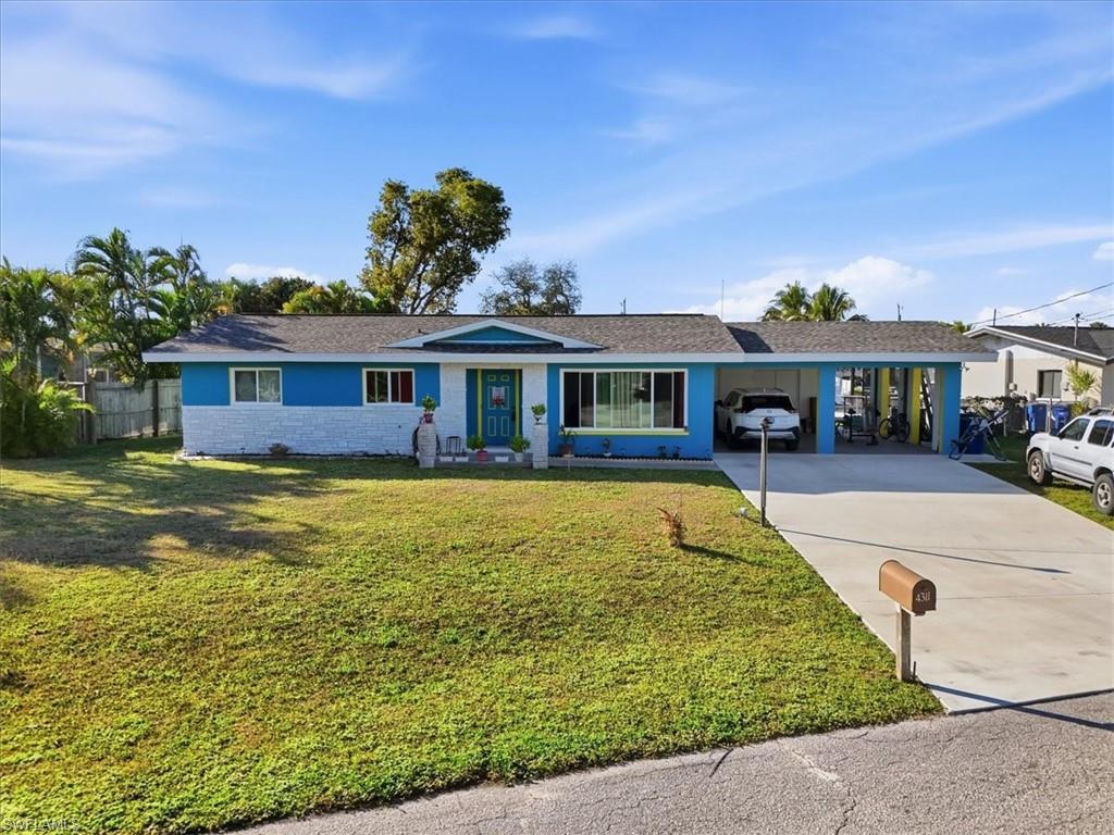 Image 2: Ranch-style home with a carport, concrete driveway, roof with shingles, and stone siding