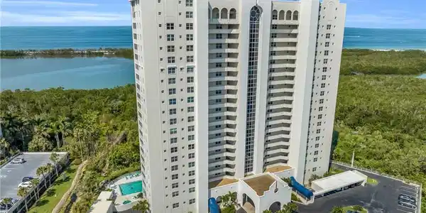 Image 4: View of apartment building / complex featuring a water view and uncovered parking
