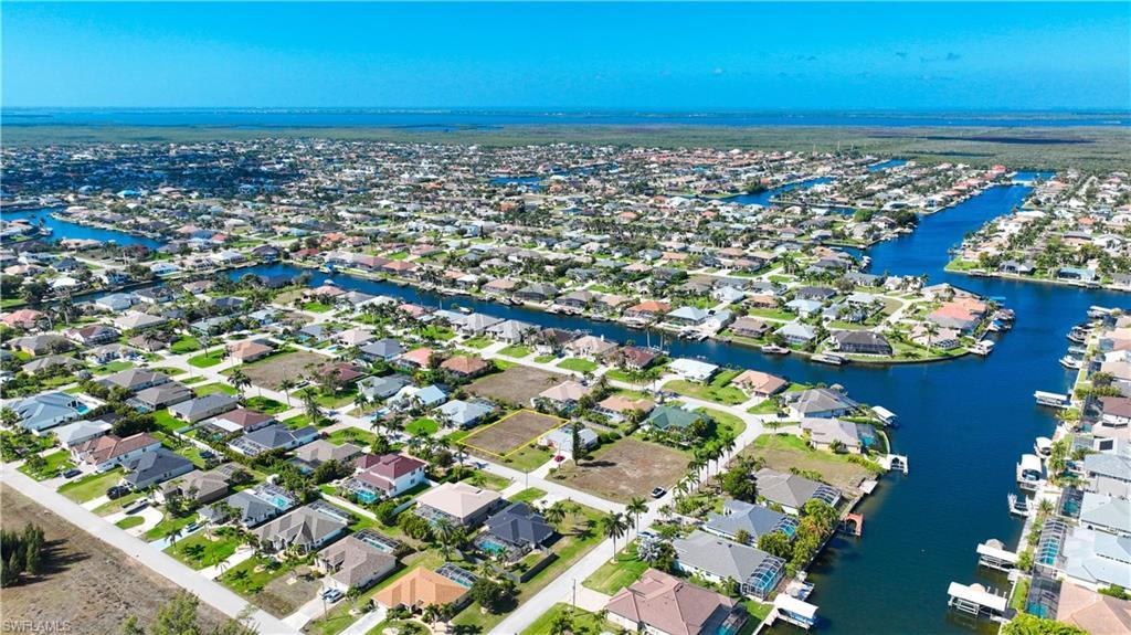 Image 3: Aerial perspective of suburban area with a nearby body of water
