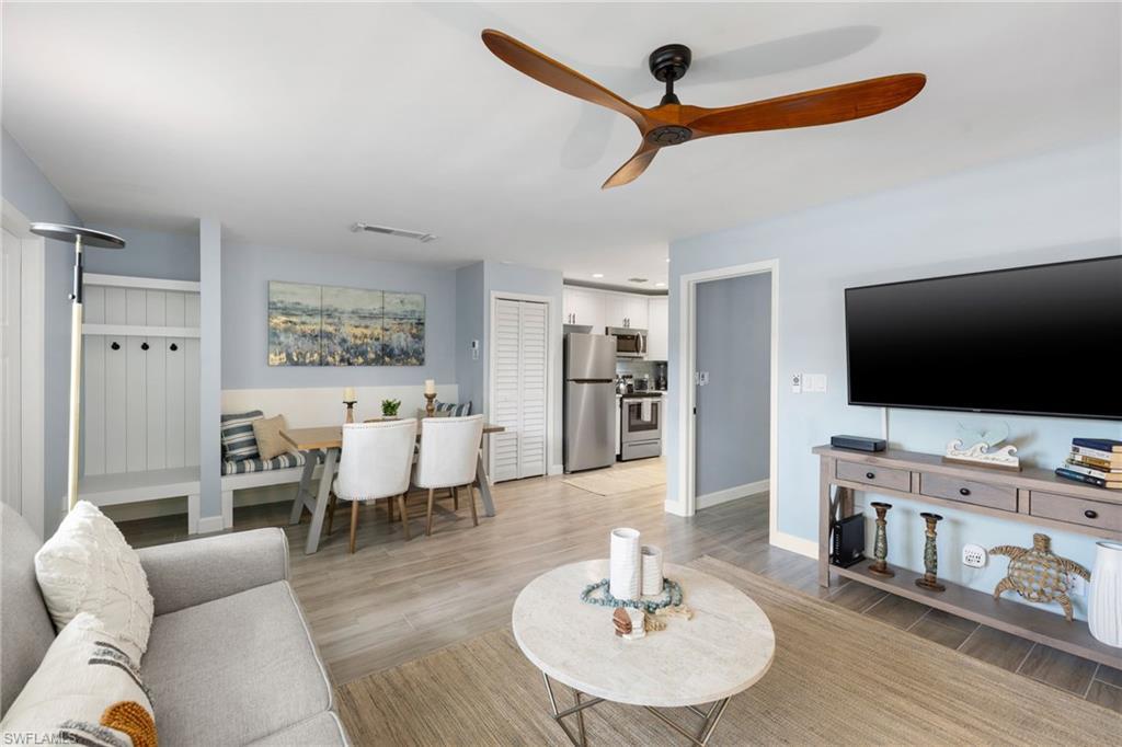 Image 2: Living area featuring light wood-style flooring and ceiling fan