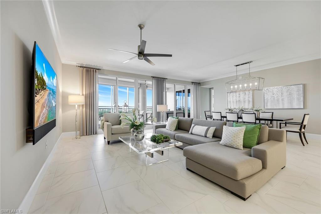 Image 2: Wide-open great room with soaring ceilings, sleek tile flooring, and walls of glass filling the space with beautiful natural light!