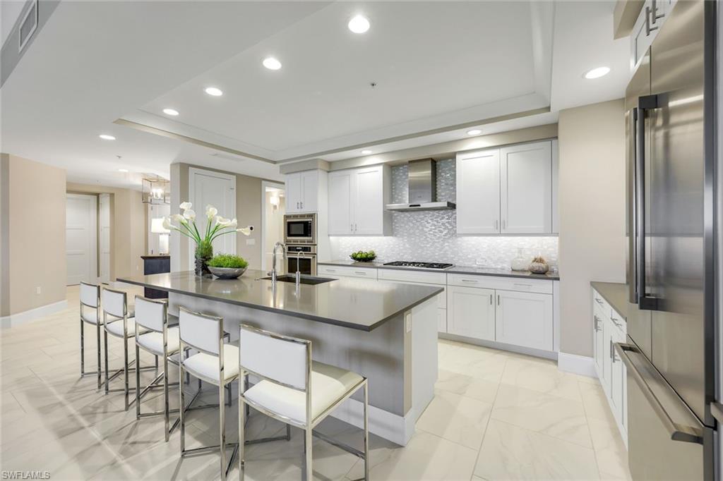 Image 3: Beautiful and highly functional.  you will love this chef&rsquo;s kitchen with oversized island seating, sleek cabinetry, and endless counter space for cooking, gathering, and casual dining.