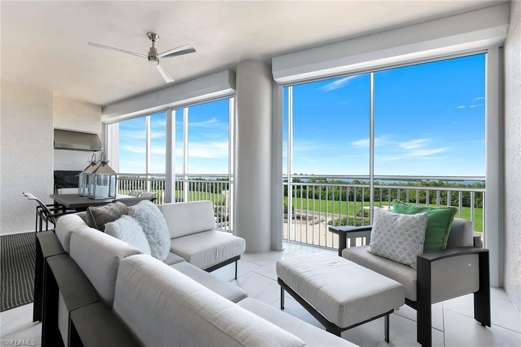 Image 4: Expansive screened lanai with comfortable lounge seating and stunning wide-open views &mdash; the perfect place to relax and soak in the Florida breeze!