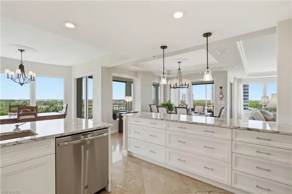Image 1: Bright, open kitchen with expansive countertops, abundant cabinetry, and scenic views.