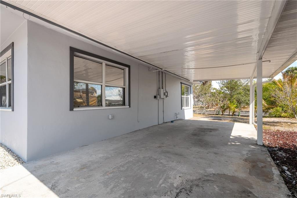 Image 3: View of patio / terrace featuring a carport