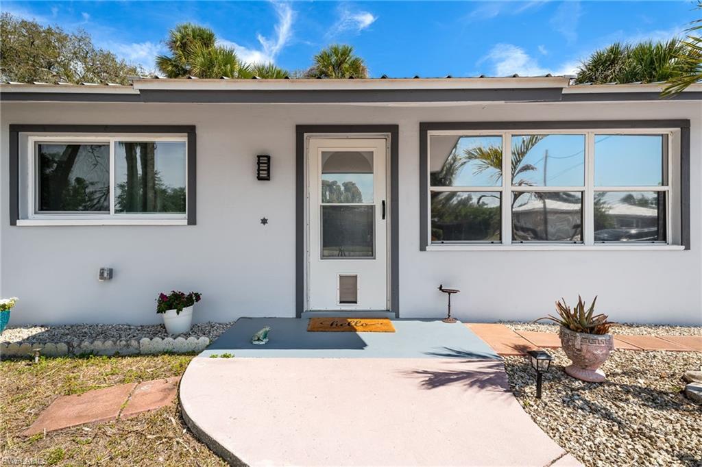 Image 4: Property entrance featuring stucco siding