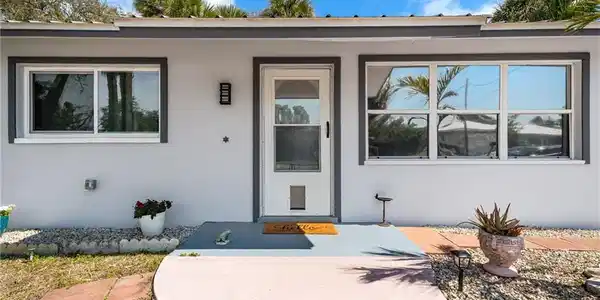 Image 4: Property entrance featuring stucco siding