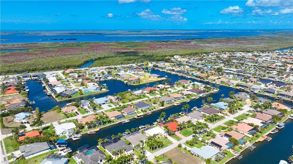 Image 4: Aerial perspective of suburban area featuring a large body of water