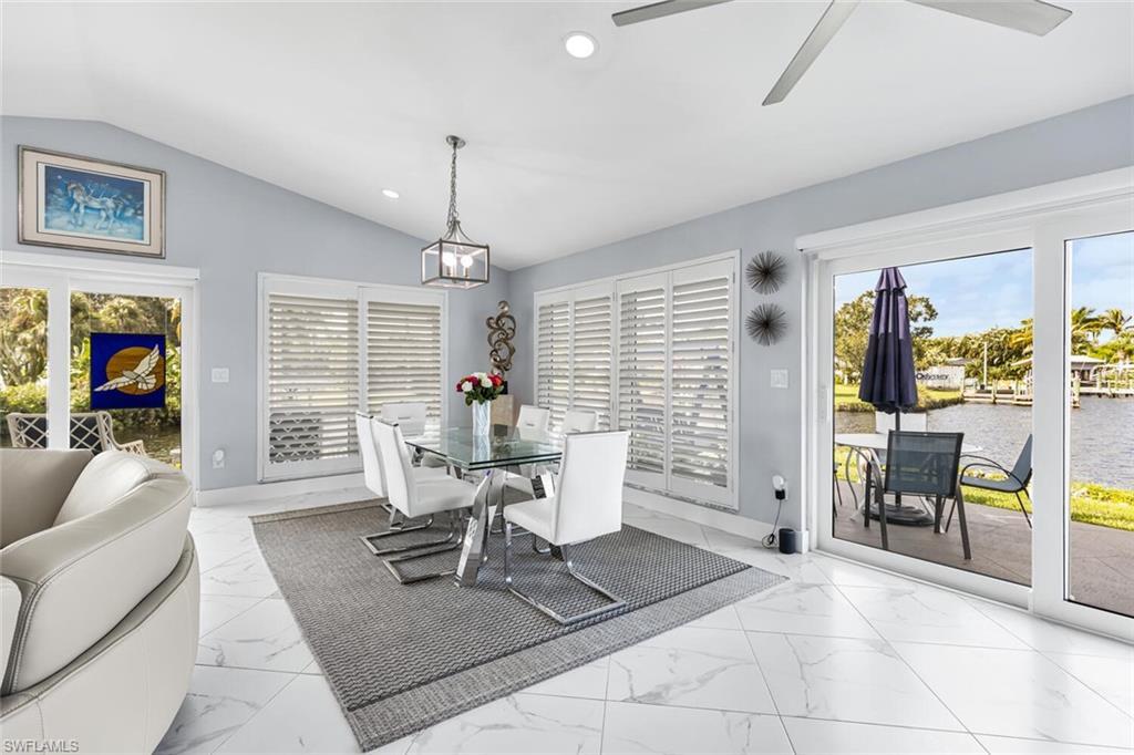 Image 4: Dining room windows are adjustable wooden plantation shutters. Plenty of room to host larger dinners with spectacular views west.  Watch sunset from dining room.