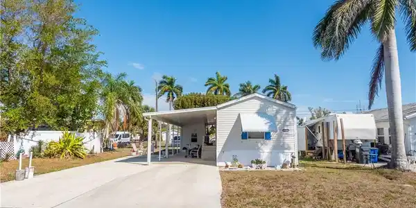 Image 4: Manufactured / mobile home with a carport and driveway