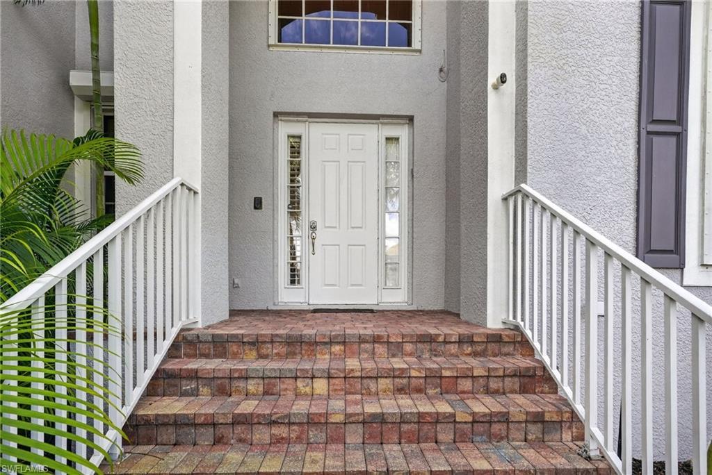 Image 2: Doorway to property with stucco siding