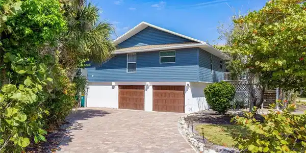 Image 3: View of front of property featuring decorative driveway and an attached garage