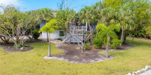 Image 4: View of green lawn featuring stairway and a deck