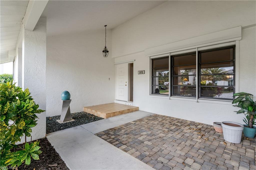 Image 3: Entrance to property with a porch and stucco siding