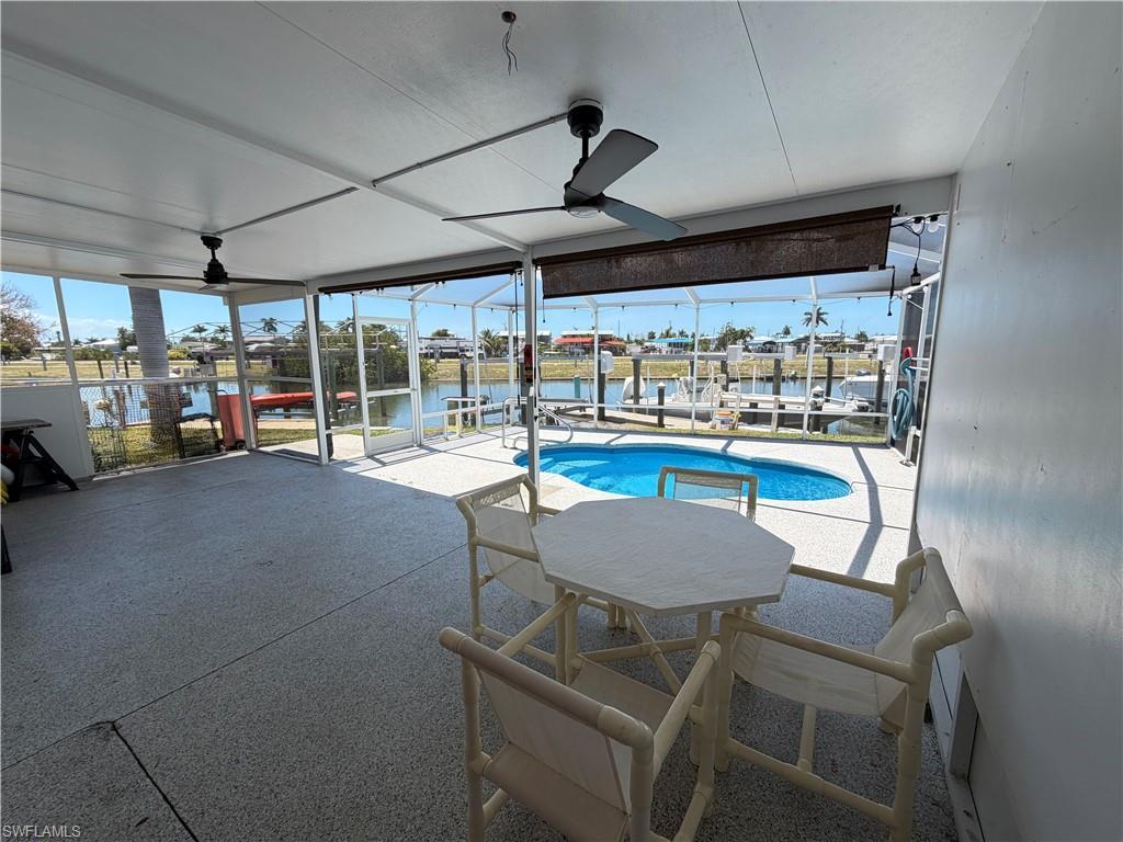 Image 4: Spacious screened-in patio and entertaining area with direct views of the canal and pool