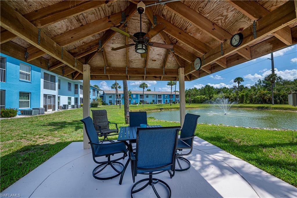 Image 4: View of patio featuring a water view, outdoor dining area, and a ceiling fan
