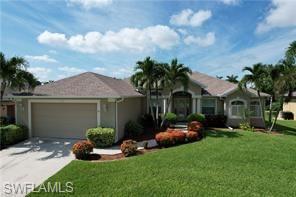 Image 2: Ranch-style home with a front yard, an attached garage, and driveway