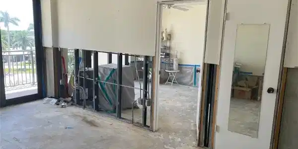 Image 3: Impact sliding glass doors installed. Demo was started in entire unit.