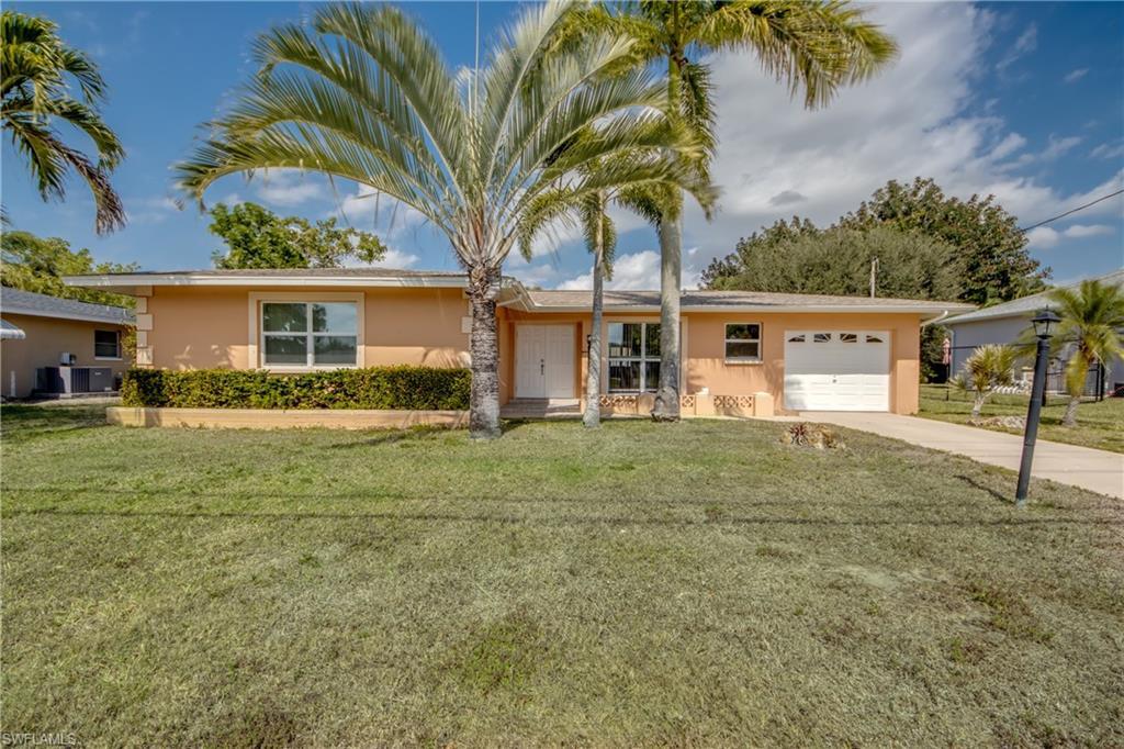 Image 1: Ranch-style house with stucco siding, a garage, concrete driveway, and a front lawn