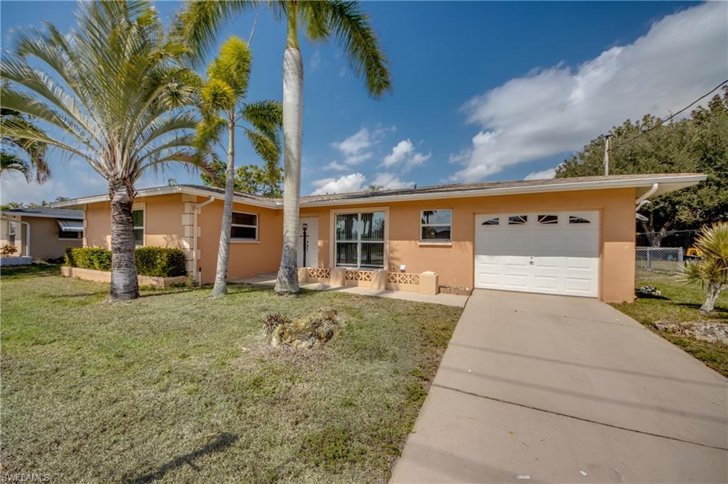 Image 2: Single story home featuring stucco siding, a garage, and driveway