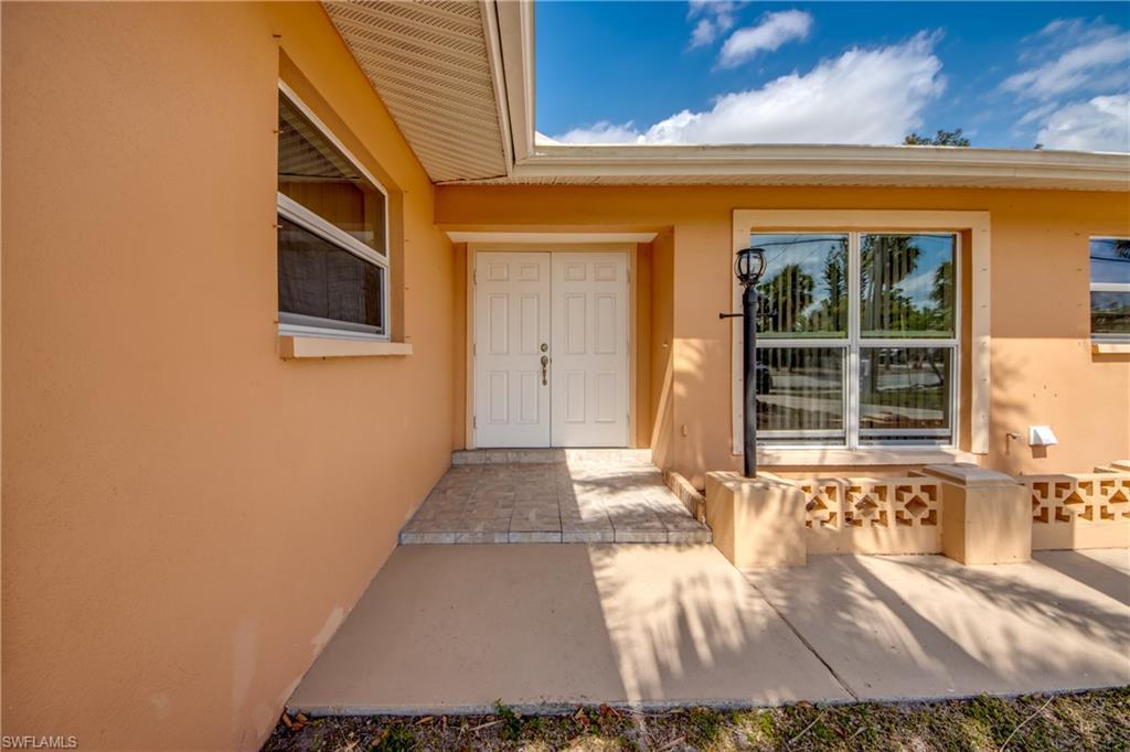 Image 3: Property entrance with stucco siding