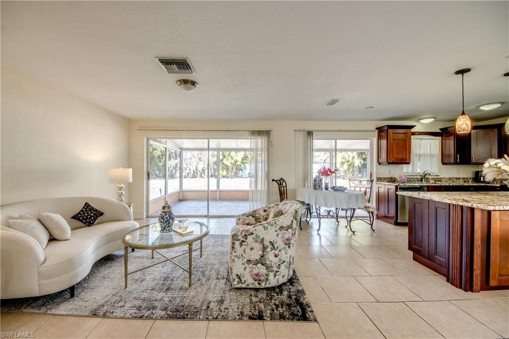 Image 4: Living room with plenty of natural light and light tile patterned flooring