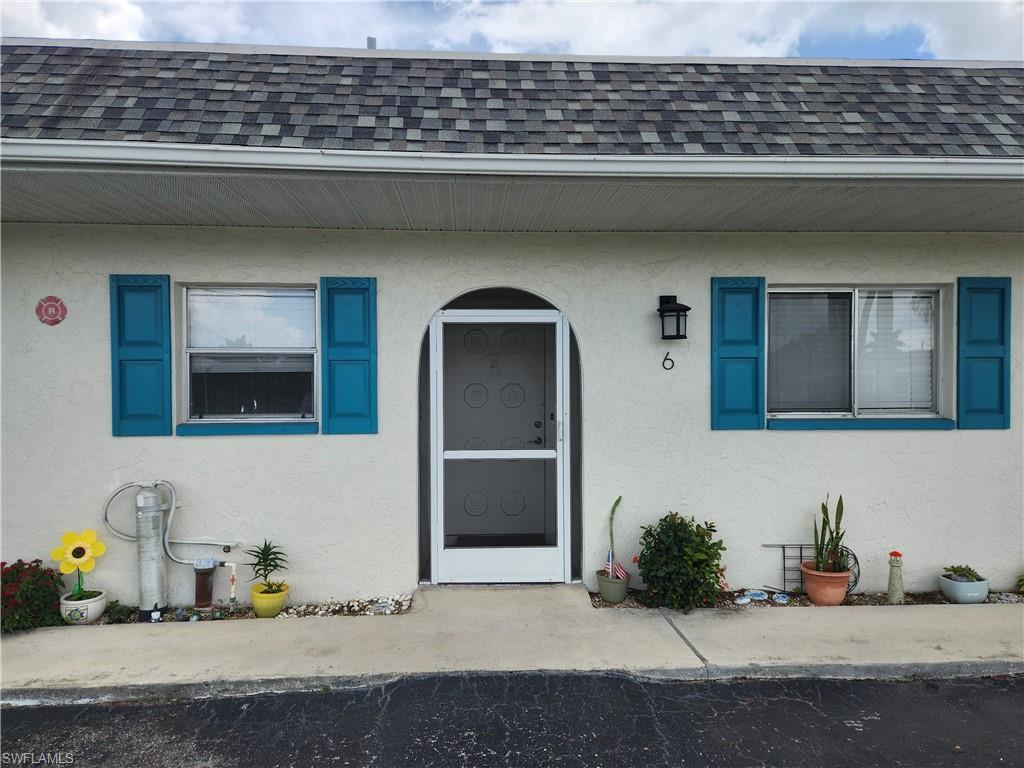 Image 1: View of exterior entry with stucco siding