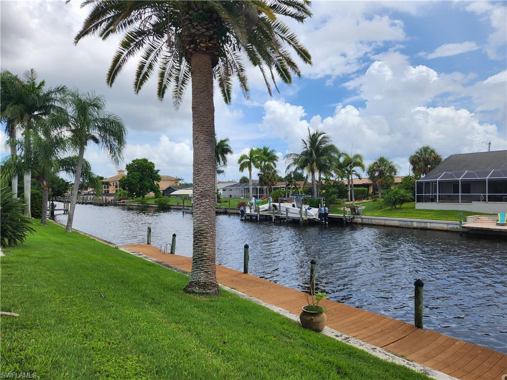 Image 2: Dock area featuring a yard, a water view, and a residential view