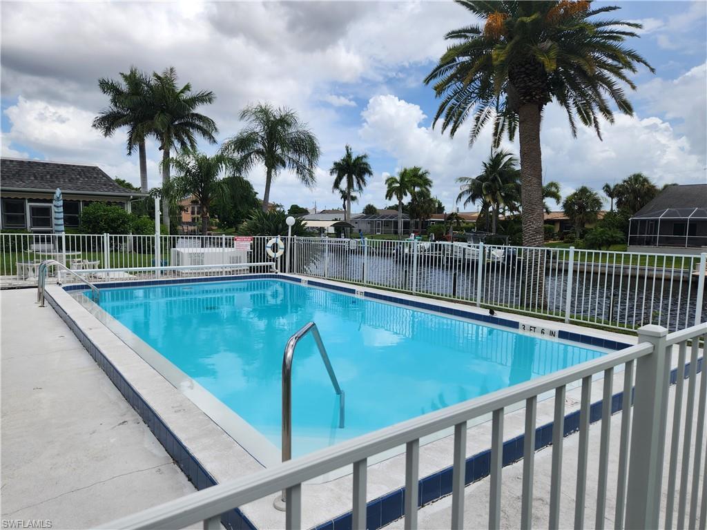 Image 3: Community pool featuring a patio