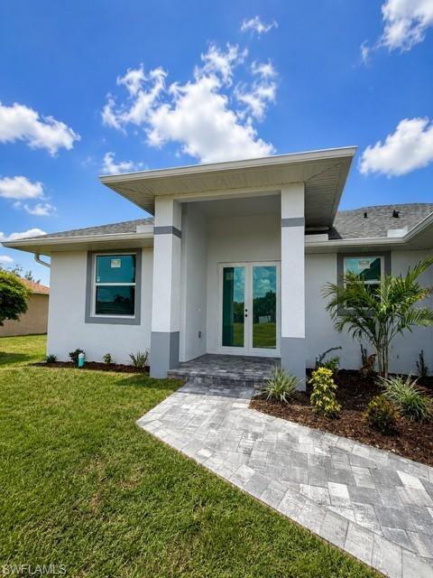 Image 2: Welcoming covered entry leading into a bright, open-concept interior.
