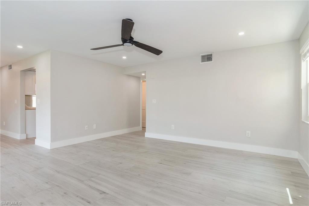 Image 2: Empty room with a ceiling fan, light wood-style floors, and recessed lighting