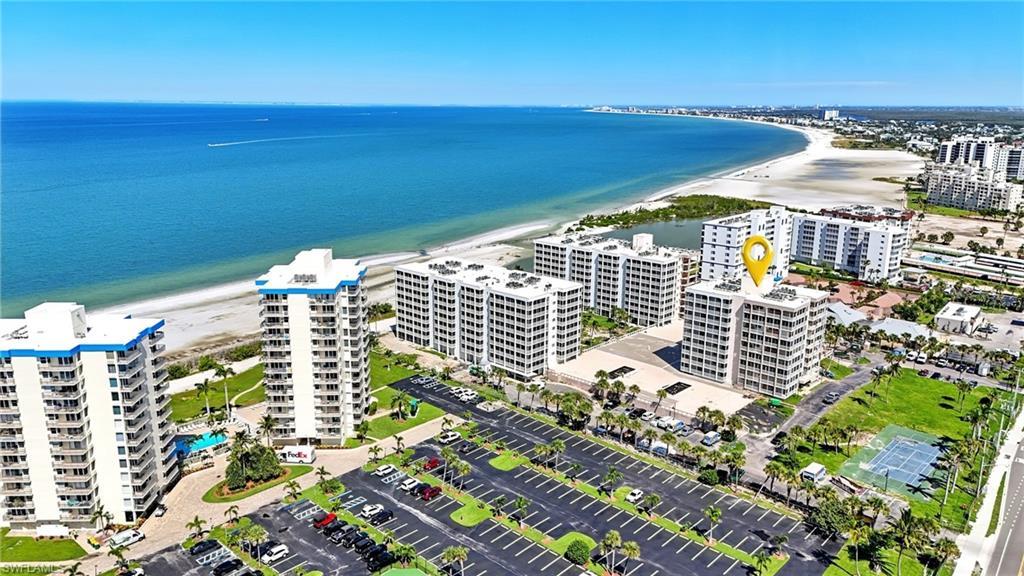 Image 2: Drone / aerial view of condominium complex / building and extended coastline - Virtually Edited Image