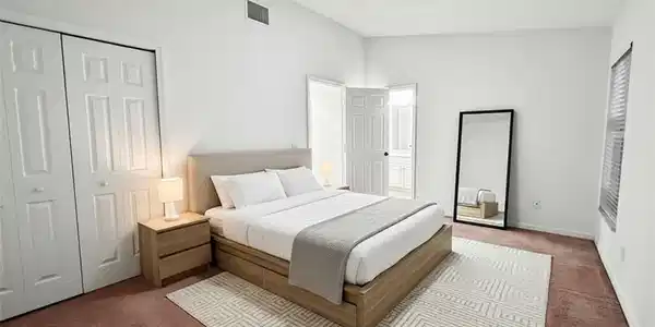 Image 4: Bedroom with carpet and a closet