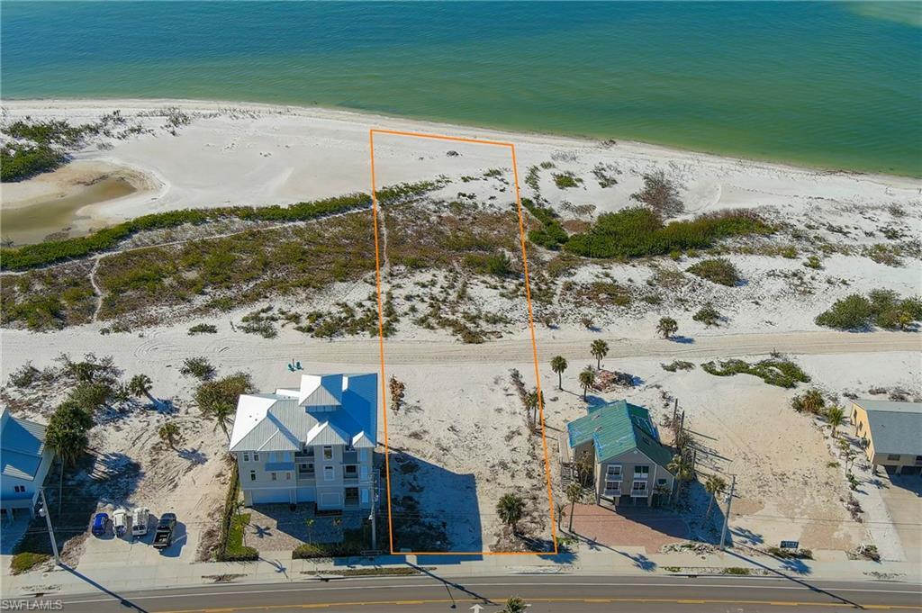 Image 2: Bird's eye view featuring a water view and a beach view