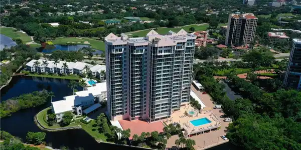 Image 4: Aerial view of apartment complex / building and a large body of water