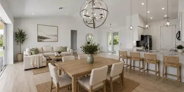 Image 2: Vaulted ceilings, wood-finish flooring, recessed lighting, kitchen island with seating, and sliding glass doors. virtually staged
