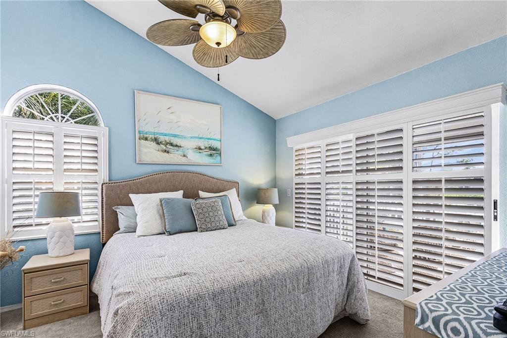 Image 4: Bedroom featuring carpet flooring, vaulted ceiling, and ceiling fan