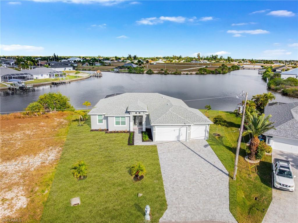 Image 2: Aerial perspective of suburban area featuring a nearby body of water