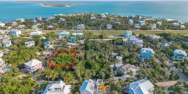 Image 2: Aerial view of lot (outlined in red) nestled among established island homes &mdash; just a short walk to the North Captiva airstrip and surrounded by the island's most desirable residential neighborhood.