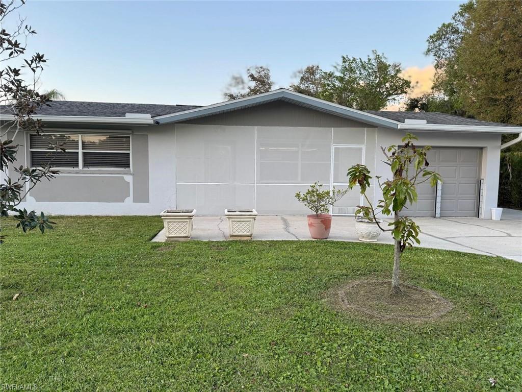 Image 1: Ranch-style home featuring a front lawn, an attached garage, stucco siding, and roof with shingles