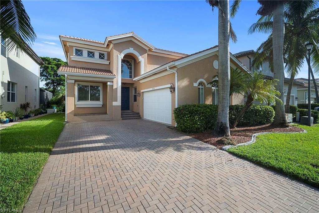 Image 1: Mediterranean / spanish home with stucco siding, decorative driveway, a front yard, and a tiled roof