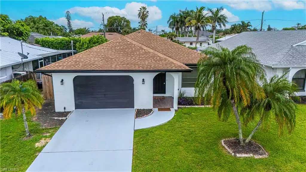 Image 1: Single story home with stucco siding, roof with shingles, driveway, and a garage