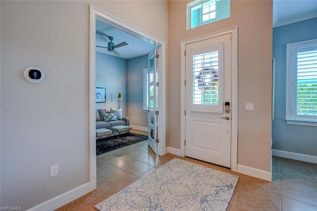 Image 4: Entrance foyer featuring a ceiling fan and light tile patterned floors