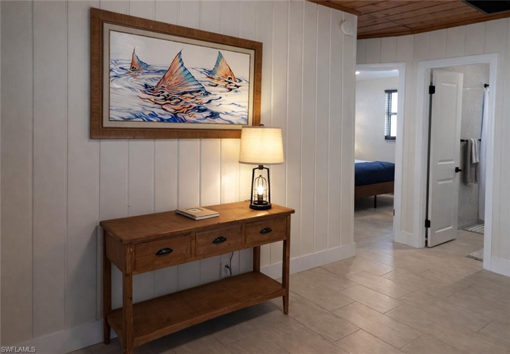 Image 4: Vertical shiplap paneling complements the wood-finish ceiling and flooring