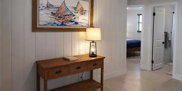 Image 4: Vertical shiplap paneling complements the wood-finish ceiling and flooring