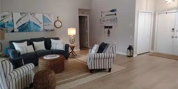 Image 3: Living area with wood finished floors, a high ceiling, ceiling fan, and ornamental molding