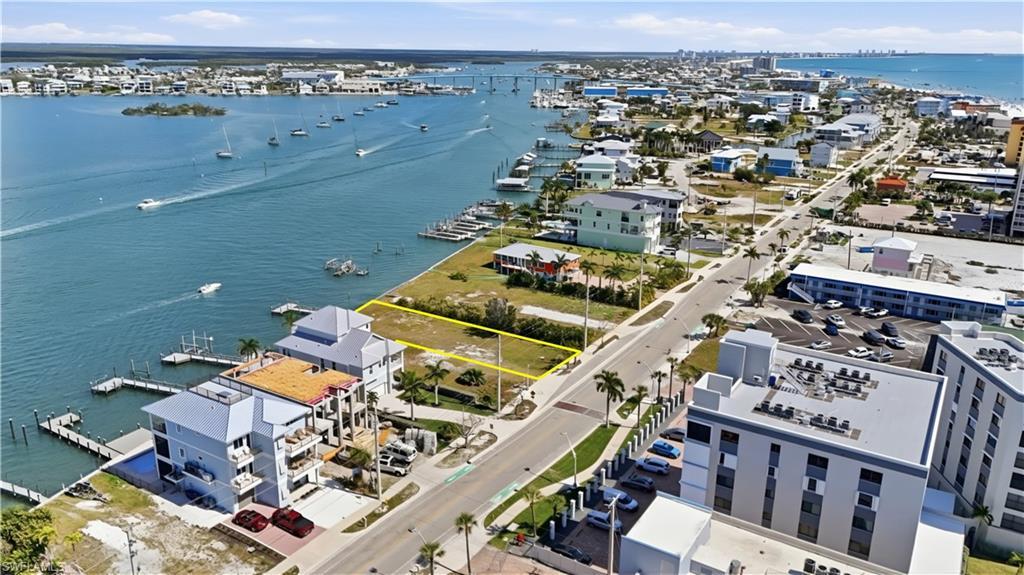Image 4: View of property location with a large body of water and property parcel outlined - Virtually Edited Image