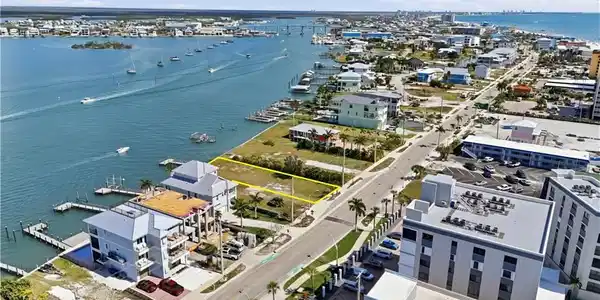 Image 4: View of property location with a large body of water and property parcel outlined - Virtually Edited Image